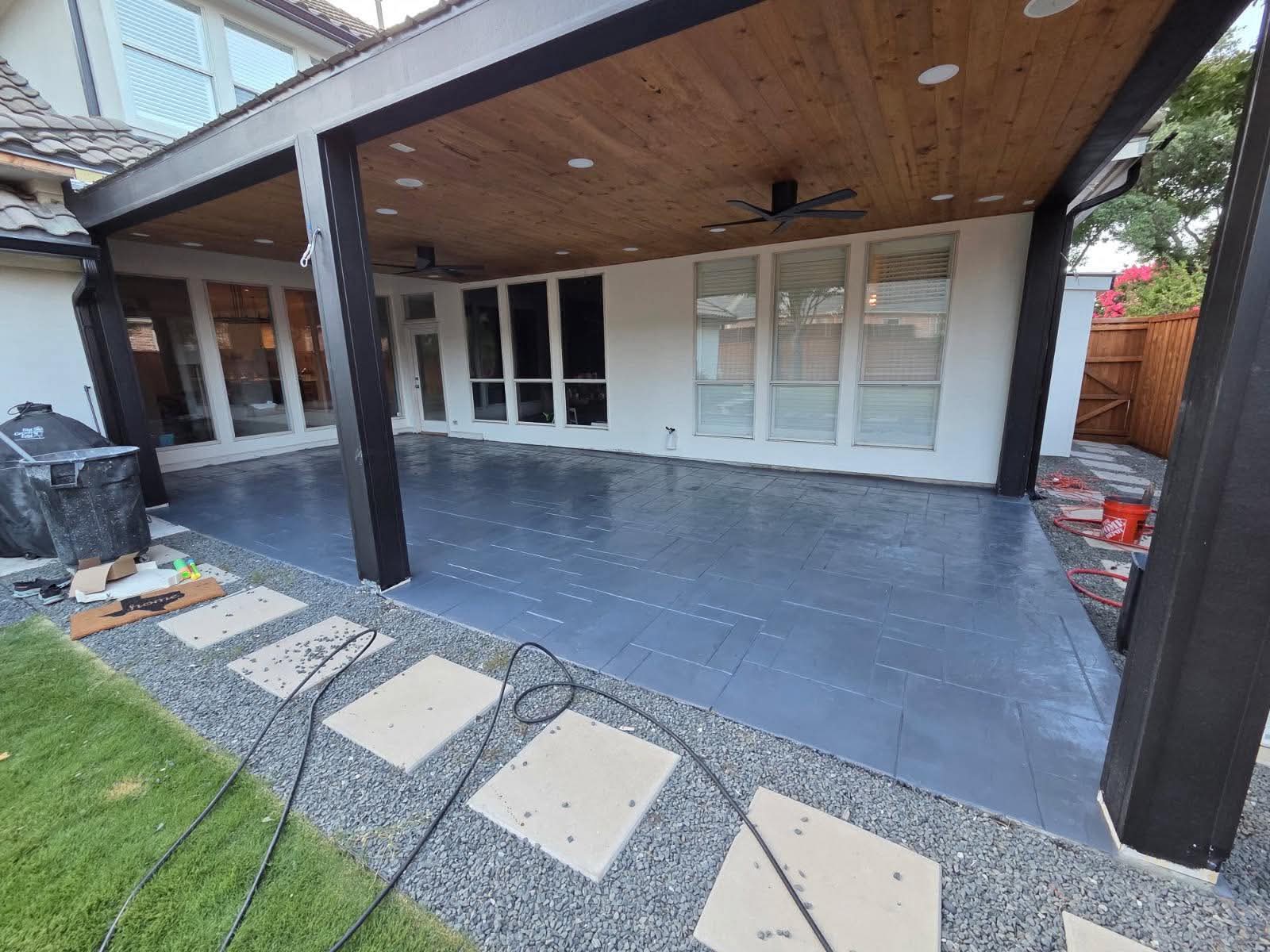 Covered patio with dark stamped concrete floor