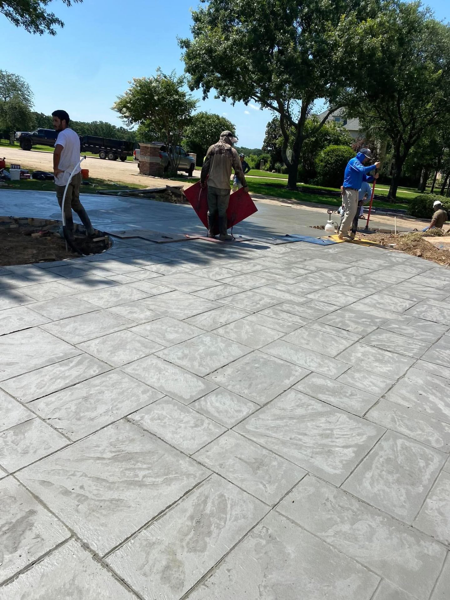 Crew stamping a large ashlar driveway