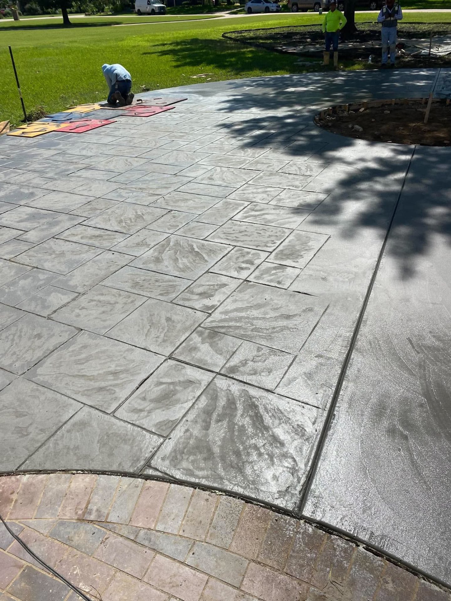 Stamped concrete patio receiving its finishing touches