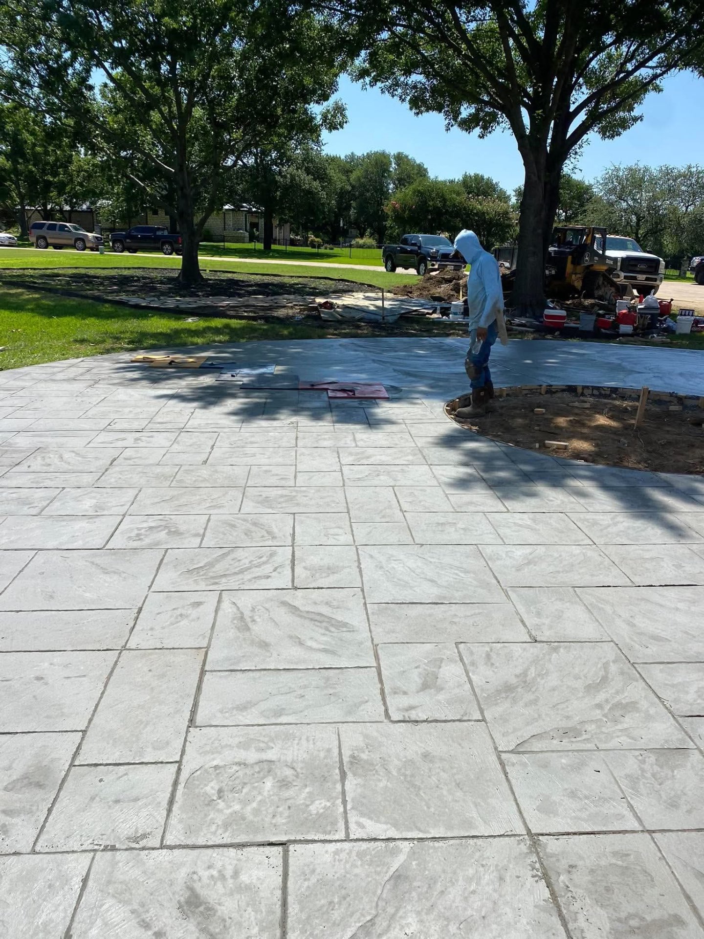 Crew stamping a large ashlar concrete patio